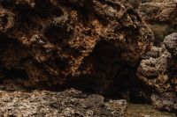 Kaboompics - Shallow Rock Pool Beneath a Shadowed Coastal Overhang
