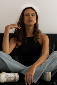 Kaboompics - Front Portrait of Woman Touching Her Hair on Black Chair