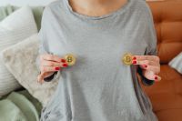 Kaboompics - Woman Holding Two Bitcoin Coins at Chest
