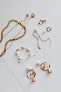 Kaboompics - Gold jewellery on white marble - necklace, bracelets, earrings