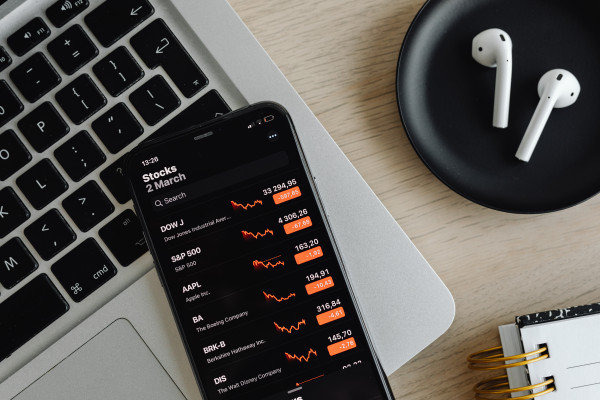 Phone - stock exchange - charts - AirPods - laptop. Ideal for workplace ...