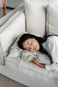 Kaboompics - Woman Relaxing on a Sofa with Eyes Closed