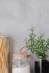 Kaboompics - Neutral Copy Space with Rosemary and Glass Pantry Containers along the Lower Edge