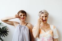Kaboompics - Two Women Applying Rainbow Face Paint Together