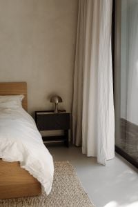 Neutral Bedroom Interior Design with White Bedding, Natural Light and a Dog