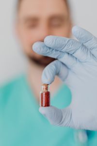 Kaboompics - Doctor Holding Small Treatment Vial Close-Up