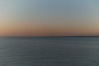 Kaboompics - Minimalist Sunset Seascape Background, Pastel Orange Sky and Sea
