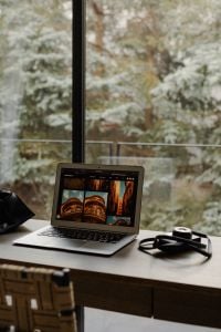 Kaboompics - Laptop and Camera Beside Window With Garden View