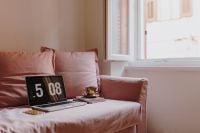 Kaboompics - Bright Window Framing a Laptop and Coffee on Pink Sofa