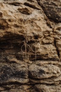 Kaboompics - Minimal Gold Drop Earrings Styled on Malta Limestone