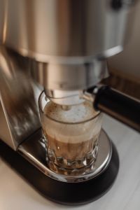 Kaboompics - Layered Coffee with Milk Foam Under Espresso Machine
