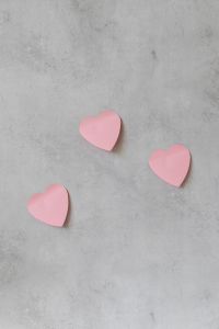 Kaboompics - Three Pink Paper Hearts on Gray Concrete