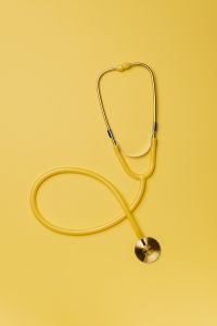 Kaboompics - Soft-Focus Yellow Stethoscope on Matching Yellow Backdrop, Minimal Medical Background