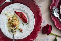 Kaboompics - Seafood Pasta and Crayfish on Festive Red Table Setting with Rose