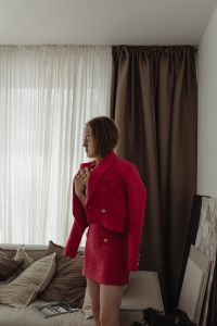 Kaboompics - Woman in a Fuchsia Blazer Beside a Sofa