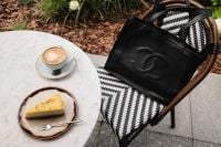 Kaboompics - Black Leather Handbag Beside Coffee and Cake at a Cafe