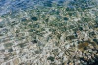 Kaboompics - Abstract Turquoise Water over Pale Shore Stones