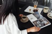 Kaboompics - Woman Reading a Magazine with Coffee in the Kitchen