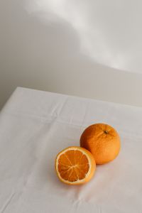 Kaboompics - Whole and Halved Oranges in the Lower Right, Minimal White Background with Copy Space