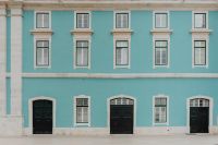 Kaboompics - Symmetrical Teal Facade with Black Doorways and White-Trimmed Windows