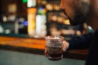 Kaboompics - Handsome young man having a whiskey in a pub
