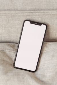 Kaboompics - Close-Up Angled Phone Screen Mockup on Textured Beige Fabric