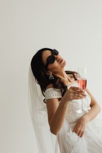 Kaboompics - Playful Wedding Reception Look With Sunglasses and a Raised Glass