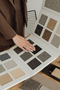 Kaboompics - Hands Comparing Exterior Plaster Samples in Finish Catalog
