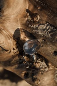 Kaboompics - Silver Statement Ring with a Smoky Gray Stone on Driftwood