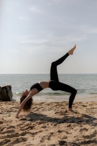Kaboompics - Woman Practicing Acroyoga on the Beach