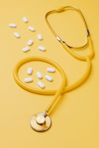 Kaboompics - Yellow Stethoscope and White Medication Flat Lay, Medical Clinic Banner Background