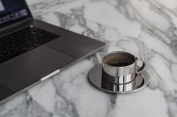 Kaboompics - Laptop and Chrome Coffee Cup with Sunlit Shadows