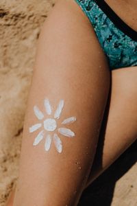 Kaboompics - White Sun Body Paint Design on Tanned Skin, Beach Close-Up