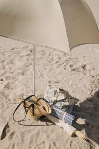 Kaboompics - Close-Up of Beach Shade, Straw Bag and Folded Textiles