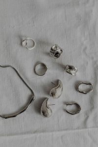 Kaboompics - Silver Jewelry Arranged on White Fabric