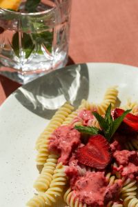 Kaboompics - Pink Fusilli Pasta With Strawberries and Mint on White Plate