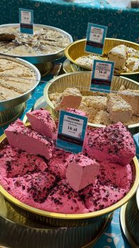 Kaboompics - Pink Pomegranate Halva With Assorted Flavors At A Market Stall