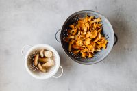 Kaboompics - Overhead View of Chanterelles and Boletes in Colanders