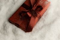 Kaboompics - Burgundy Gift with Velvet Bow in Snow