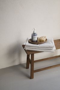Kaboompics - Wooden Bench with Soap and Loofah on Folded White Towels