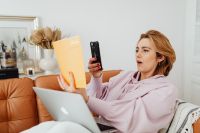 Kaboompics - Woman Photographing Book Content While Working from Home