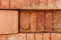 Kaboompics - Close-Up Stacked Brick Wall with Weathered Joints