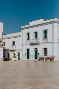 Kaboompics - White Townhouse and Bench in a Quiet Calasetta Piazza