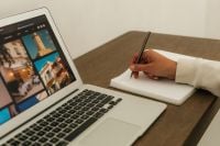 Kaboompics - Remote Work Laptop Desk Writing In Notebook