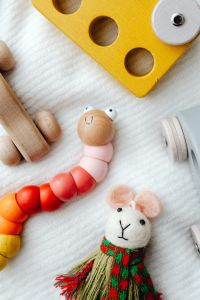 Kaboompics - Yellow Wooden Puzzle Car and Colorful Bead Caterpillar Toy Close-Up