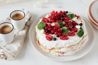 Kaboompics - White Berry Pavlova Cake Served Beside Two Espresso Cups, Close Food Still Life