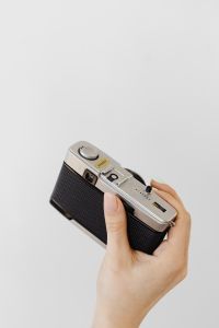 Kaboompics - Vintage Camera Top Plate and Rewind Dial in a Hand, Detail Shot
