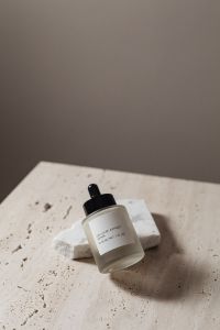 Kaboompics - Glass Dropper Serum Bottle Mockup on Textured Stone with Soft Shadows
