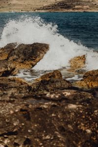 Kaboompics - Ocean Wave Crest Breaking Over Golden Coastal Rocks