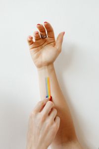 Kaboompics - Hand Painting a Rainbow Stripe on a Forearm for Pride